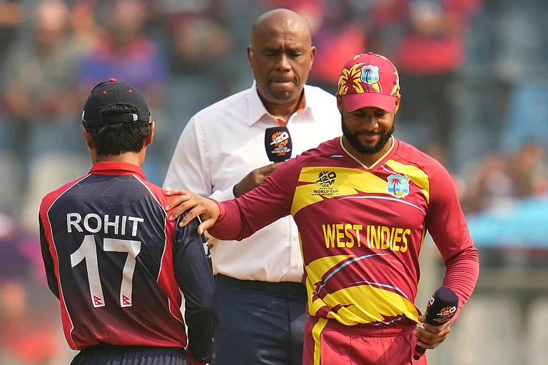West Indies' captain Shai Hope, right, pats on the shoulder of Nepal's captain Rohit Paudel after the coin toss during the T20 World Cup cricket match between Nepal and West Indies in Mumbai. - | Photo: AP/Rafiq Maqbool