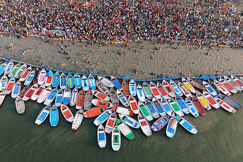 People take a holy dip at Sangam on the occasion of 'Maha Shivaratri', in Prayagraj.