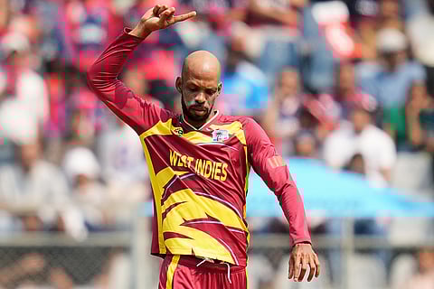 West Indies' Roston Chase celebrates the wicket of Nepal's Gulshan Jha during the T20 World Cup cricket match between Nepal and West Indies in Mumbai.