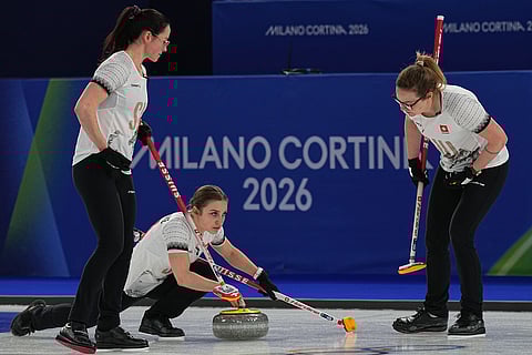 Switzerland's Selina Witschonke, Alina Paetz and Carole Howald in action during the women's curling round robin session against Canada at the 2026 Winter Olympics, in Cortina d'Ampezzo, Italy.