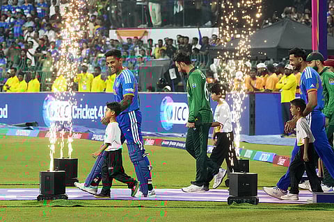 India's captain Suryakumar Yadav, left, smiles as he and Pakistan's captain Salman Ali Agha walk out onto the field for the T20 World Cup cricket match between India and Pakistan in Colombo, Sri Lanka.