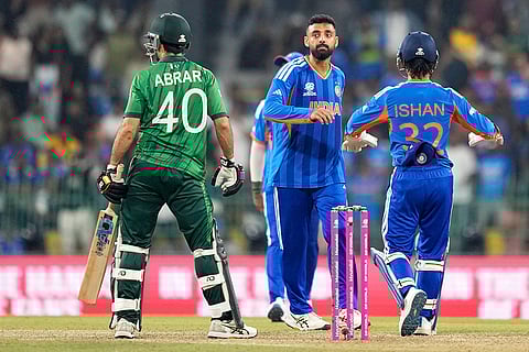 India's Varun Chakravarthy, center, celebrates the wicket of Pakistan's Abrar Ahmed, left, during the T20 World Cup cricket match between India and Pakistan in Colombo, Sri Lanka.