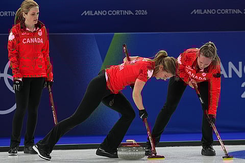 Canada's Rachel Homan, Sarah Wilkes and Tracy Fleury in action during the women's curling round robin session against Switzerland at the 2026 Winter Olympics, in Cortina d'Ampezzo, Italy.