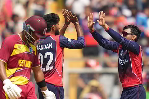Nepal's Nandan Yadav, second left, celebrates the wicket of West Indies' Brandon King during the T20 World Cup cricket match between Nepal and West Indies in Mumbai.