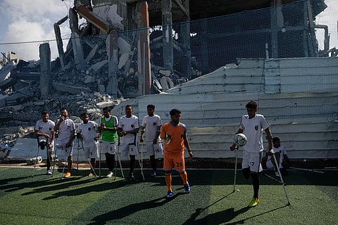 Palestinian amputee soccer players train on a newly built field surrounded by buildings destroyed in Israeli army bombardments during the Israel-Hamas war, in Gaza City.