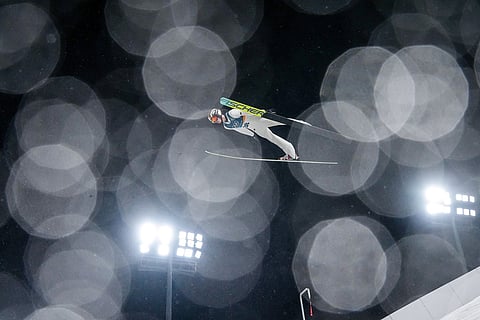 Kacper Tomasiak, of Poland, soars through the air during the ski jumping men's large hill individual at the 2026 Winter Olympics, in Predazzo, Italy.