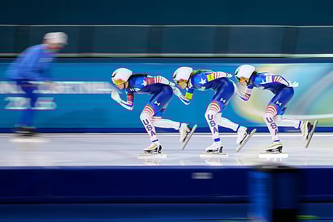 Brittany Bowe of the U.S., front, is followed by teammates Mia Manganello, center, and Giorgia Birkeland, right, as they compete in the women's team pursuit quarterfinals speedskating race at the 2026 Winter Olympics, in Milan, Italy.