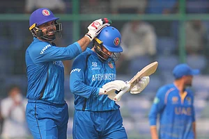 | Photo: AP/Manish Swarup : Afghanistan's Mohammad Nabi congratulate teammate Afghanistan's Azmatullah Omarzai after wining against United Arab Emirates during the T20 World Cup cricket match in New Delhi.