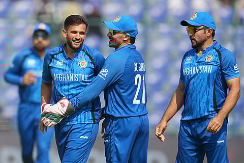 Afghanistan's Azmatullah Omarzai, centre, celebrates the wicket of United Arab Emirates' Syed Haider during the T20 World Cup cricket match between Afghanistan and United Arab Emirates in New Delhi.