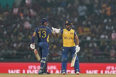 Sri Lanka's Pathum Nissanka, right, and Sri Lanka's Kusal Mendis celebrates after scoring runs during the T20 World Cup cricket match between Sri Lanka and Australia in Pallekele, Sri Lanka.