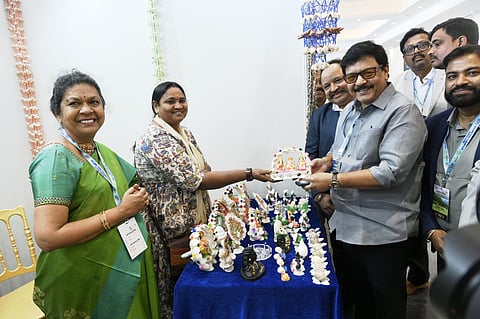 Sri Kandula Durgesh- Minister for AP Tourism interacts with artisans during a craft exhibition, appreciating traditional handcrafted creations at the AP travel mart.