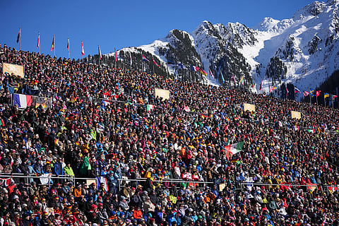 Spectators watch the start of the women's 10-kilometer pursuit biathlon race at the 2026 Winter Olympics in Anterselva, Italy.