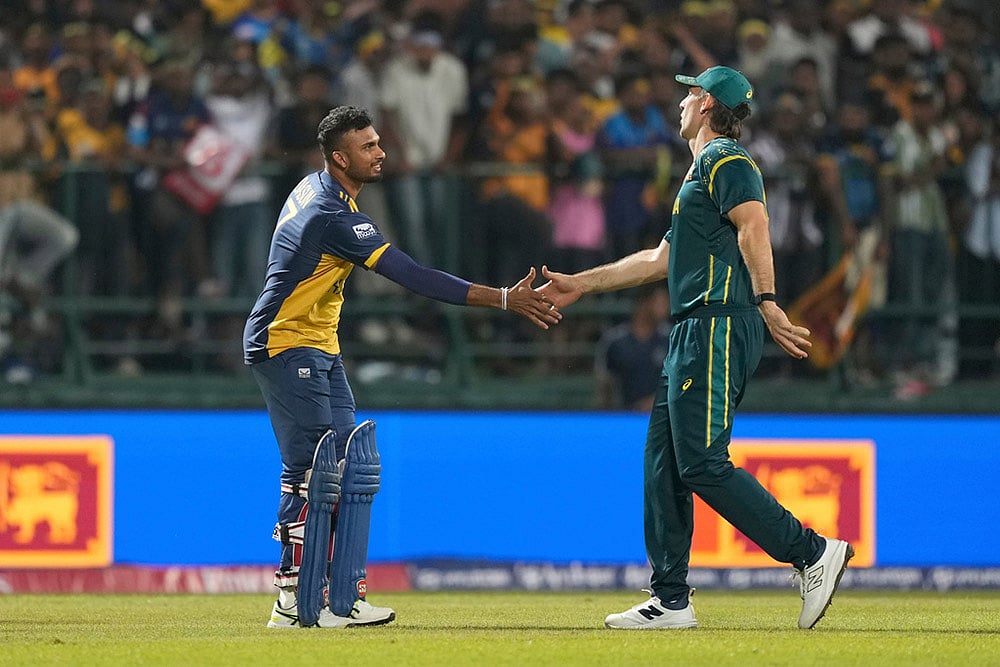 Sri Lanka's captain Dasun Shanaka, left, shake hands with Australia's captain Mitchell Marsh after they won the T20 World Cup cricket match against Australia in Pallekele, Sri Lanka. - | Photo: AP/Eranga Jayawardena