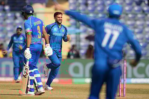Afghanistan's Azmatullah Omarzai, centre, celebrates the wicket of United Arab Emirates' Aryansh Sharma during the T20 World Cup cricket match between Afghanistan and United Arab Emirates in New Delhi.