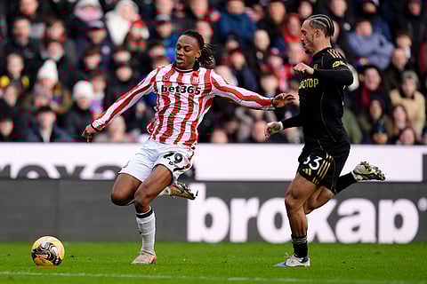 Stoke City's Lamine Cisse, left, and Fulham's Antonee Robinson battle for the ball during the English FA Cup fourth round match between Stoke City and Fulham, in Stoke, England.