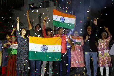 Cricket fans celebrate India's victory over Pakistan in the ICC Men's T20 World Cup 2026 cricket match, in Ahmedabad.