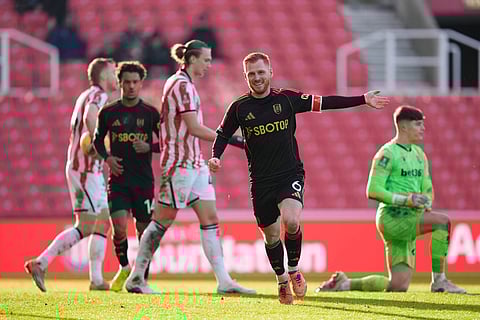 Fulham's Harrison Reed, right, celebrates after scoring his sides second goal during the English FA Cup fourth round match between Stoke City and Fulham, in Stoke, England.