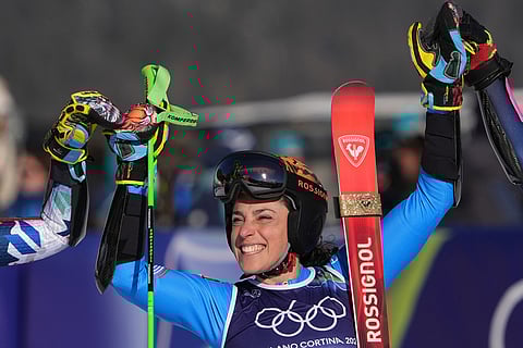 Italy's Federica Brignone celebrates winning an alpine ski, women's giant slalom race, at the 2026 Winter Olympics, in Cortina d'Ampezzo, Italy.