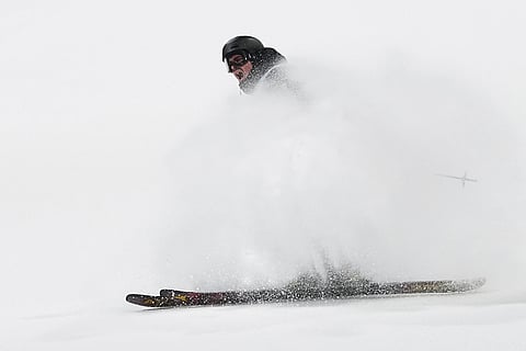 France's Matias Roche celebrates during the men's freestyle skiing big air qualifications at the 2026 Winter Olympics, in Livigno, Italy.