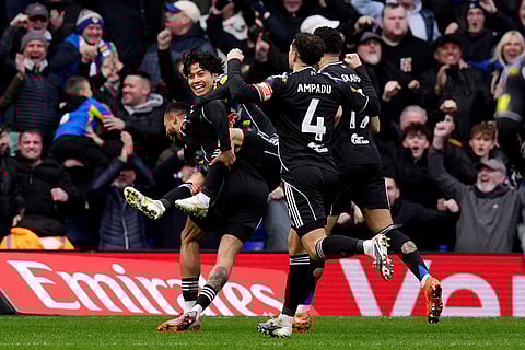 Leeds United's Lukas Nmecha, left, celebrates with Ao Tanaka, second left, after scoring his side's first goal during the Emirates FA Cup fourth round match in Birmingham, England.