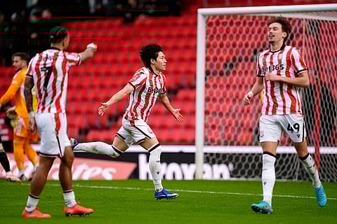 Stoke City's Bae Jun-Ho, centre, celebrates after scoring his side's first goal during the English FA Cup fourth round match between Stoke City and Fulham, in Stoke, England.