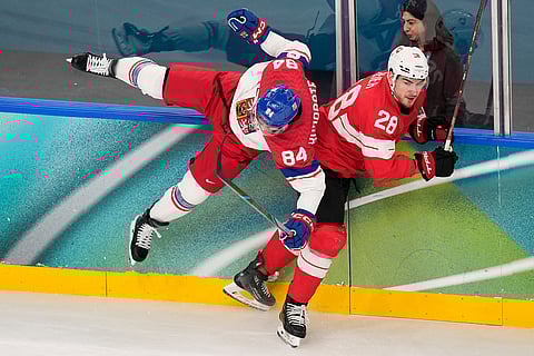 Czechia's Tomas Kundratek (84) challenges with Switzerland's Timo Meier (28) during a preliminary round match of men's ice hockey between Switzerland and Czechia at the 2026 Winter Olympics, in Milan, Italy.
