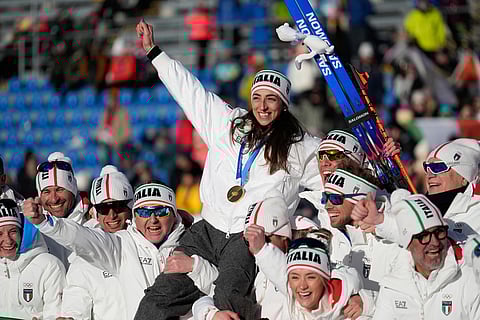 Gold medalist Lisa Vittozzi, of Italy, poses with teammates after the women's 10-kilometer pursuit biathlon race at the 2026 Winter Olympics in Anterselva, Italy.