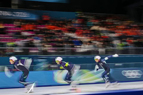 Team France with Germain Deschamps, white armband, Timothy Loubineaud, red armband, and Valentin Thiebault, yellow armband, compete in the men's team pursuit quarterfinals speedskating race at the 2026 Winter Olympics, in Milan, Italy.