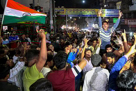 Cricket fans celebrate India's victory over Pakistan in the ICC Men's T20 World Cup 2026 cricket match, in Nagpur.