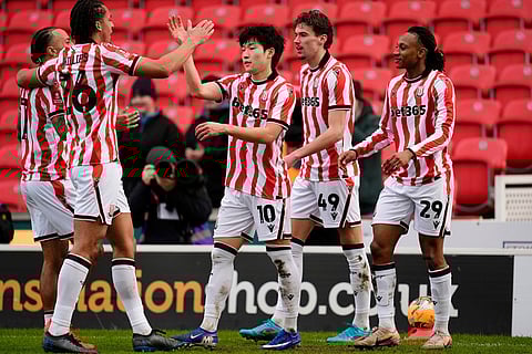 Stoke City's Bae Jun-Ho, centre, celebrates after scoring his side's first goal during the English FA Cup fourth round match between Stoke City and Fulham, in Stoke, England.