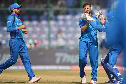 Afghanistan's Azmatullah Omarzai, centre, celebrates with teammates the wicket of United Arab Emirates' Harshit Kaushik during the T20 World Cup cricket match between Afghanistan and United Arab Emirates in New Delhi.