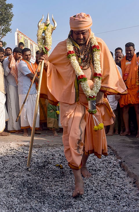 A monk walks across burning embers during the Kendotsava rituals, in Chikkamagaluru, Karnataka. 