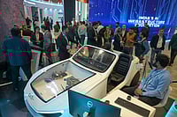 (AP Photo) :   Delegates watch an exhibition on the use of AI during an AI-Summit in New Delhi, India, Monday, Feb. 16, 2026. 