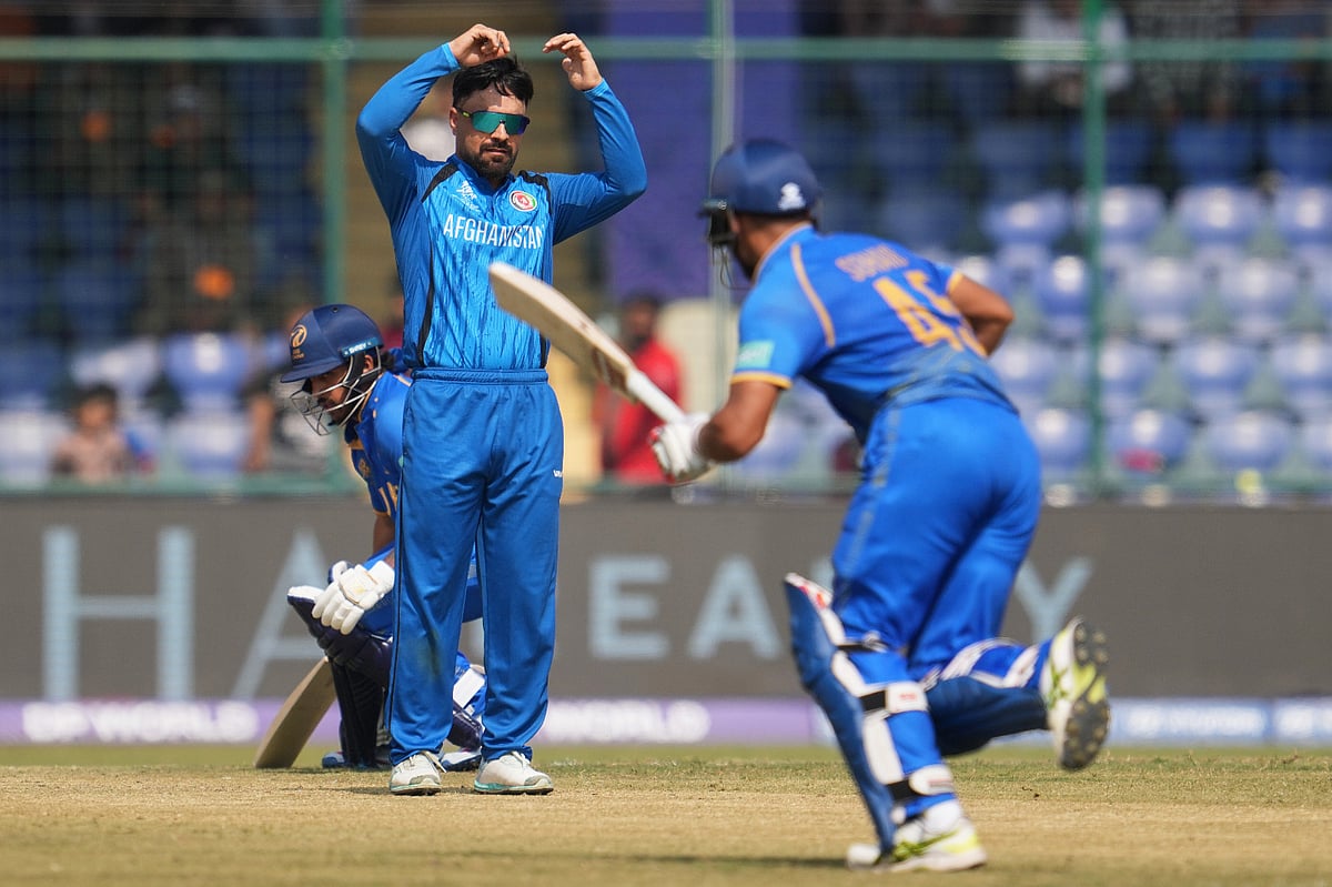 Afghanistan's captain Rashid Khan, centre, watches United Arab Emirates' Sohaib Khan after bowls a delivery during the T20 World Cup cricket match between Afghanistan and United Arab Emirates in New Delhi, India, Monday, Feb. 16, 2026.