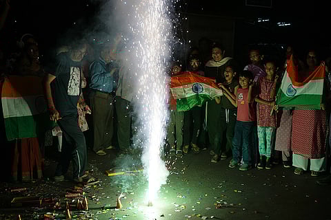 Indian fans celebrate Indian team's victory against Pakistan in ICC men's T20 World Cup cricket match played at Colombo in Sri Lanka, in Ahmedabad.