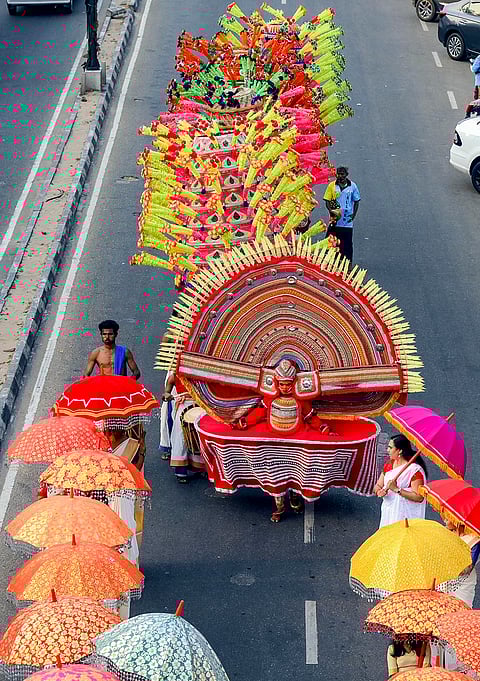 A Theyyam artist participates in a procession marking the conclusion of the BJP's South Zone election campaign rally, in Thiruvananthapuram.