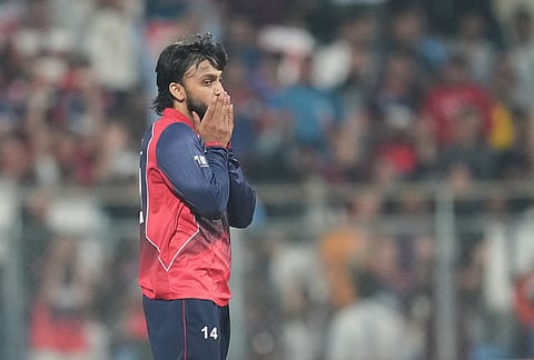 Nepal's Kushal Bhurtel celebrates the wicket of Scotland's captain Richie Berrington during the T20 World Cup cricket match between Nepal and Scotland in Mumbai.