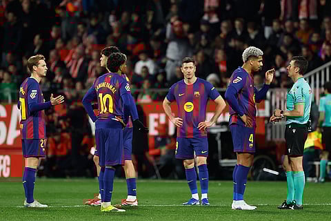 Barcelona players react during a Spanish La Liga soccer match between Girona and Barcelona in Girona, Spain.