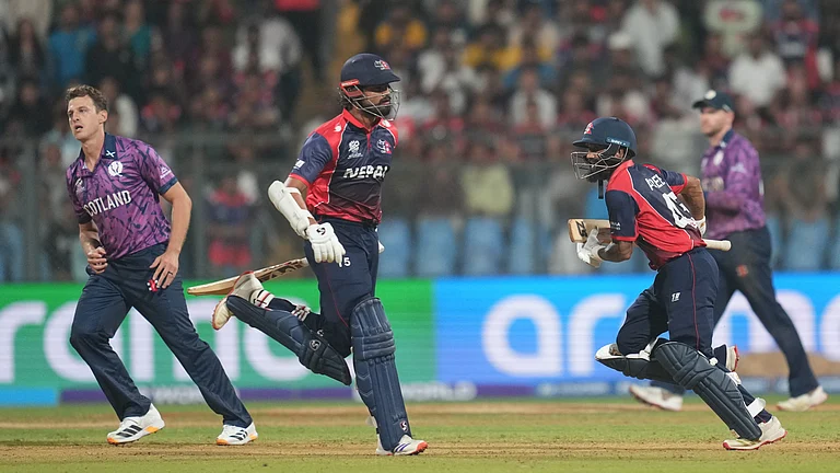 Nepal's Dipendra Singh Airee with batting partner Gulshan Jha run between the wickets to score during the T20 World Cup cricket match between Nepal and Scotland in Mumbai, India, Tuesday, Feb. 17, 2026 - (AP Photo/Rafiq Maqbool)