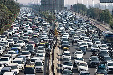 Vehicles crawl amid a heavy traffic jam near Akshardham temple, due to restrictions for the India AI Impact Summit and peak-hour rush, in New Delhi.