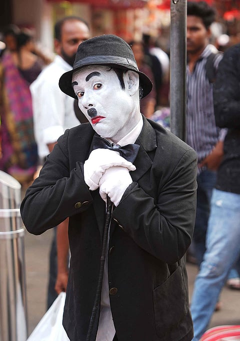 With a playful salute and signature cane in hand, Afsar Khan performs as Charlie Chaplin in the lively lanes of Dadar, turning an ordinary day in Mumbai into a scene from the silent era.