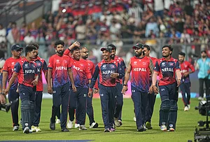 | Photo: AP/Rafiq Maqbool : Nepal cricket team walks back to the pavilion after defeating Scotland during the T20 World Cup cricket match in Mumbai.