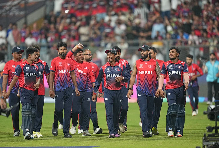Nepal cricket team walks back to the pavilion after defeating Scotland during the T20 World Cup cricket match in Mumbai. - | Photo: AP/Rafiq Maqbool
