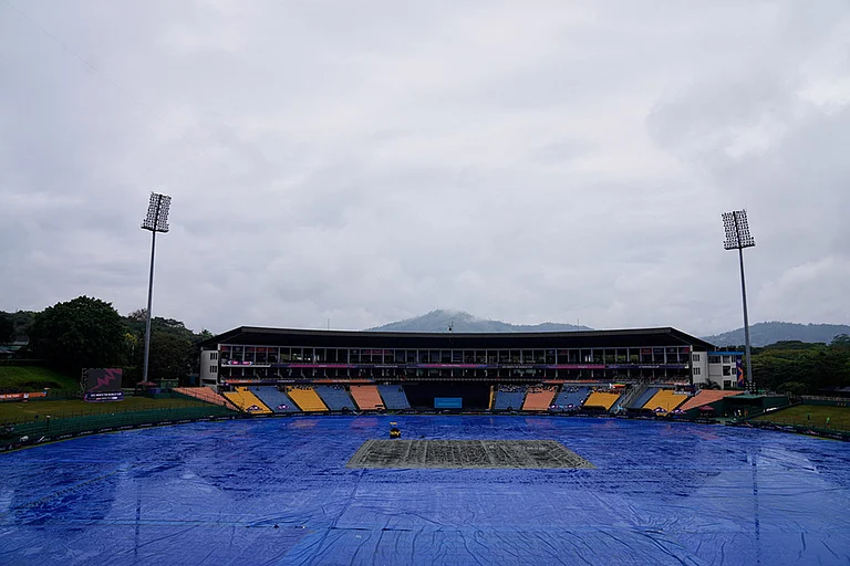 The ground is covered as rain delayed the start of play during the T20 World Cup cricket match between Ireland and Zimbabwe in Pallekele, Sri Lanka. - | Photo: AP/Eranga Jayawardena