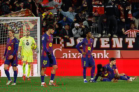Barcelona players react during a Spanish La Liga soccer match between Girona and Barcelona in Girona, Spain.