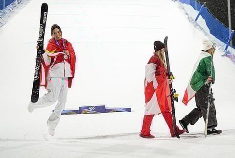 From left, silver medalist China's Eileen Gu celebrates as gold medalist Canada's Megan Oldham and bronze medalist Itay's Flora Tabanelli walk off after the women's freestyle skiing big air finals at the 2026 Winter Olympics, in Livigno, Italy.