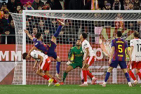 Girona's Hugo Rincon fights for the ball against Barcelona's Eric Garcia during a Spanish La Liga soccer match between Girona and Barcelona in Girona, Spain.
