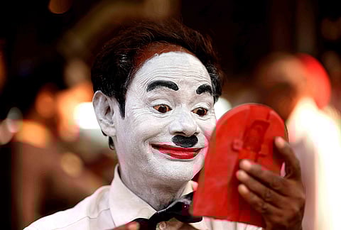 Before stepping into the bustling lanes of Dadar, Afsar Khan carefully applies his makeup, transforming into Charlie Chaplin for another day of performance in Mumbai.