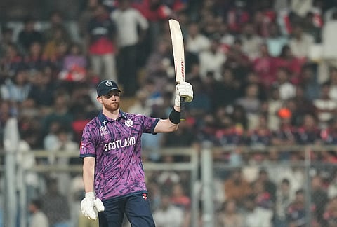 Scotland's Michael Jones celebrates his fifty runs during the T20 World Cup cricket match between Nepal and Scotland in Mumbai.