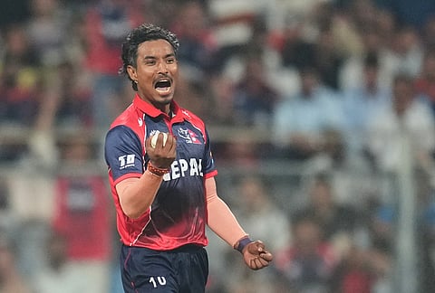 Nepal's Sompal Kami celebrates the wicket of Scotland's Brandon McMullen during the T20 World Cup cricket match between Nepal and Scotland in Mumbai.